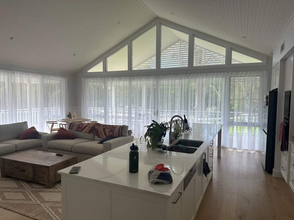 Sheer curtains installed in a Central Coast living room, allowing filtered natural light while maintaining privacy