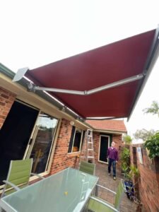 Zip system roller blinds professionally installed on a slanted ceiling structure, providing effective shade, privacy, and weather resistance. The track-guided system ensures smooth operation and keeps fabric secure even on angled designs, making it ideal for pergolas, patios, and coastal homes with raked or sloped ceilings.