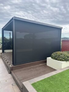 Zip blinds installed on pergola providing shade, privacy, and all-weather protection