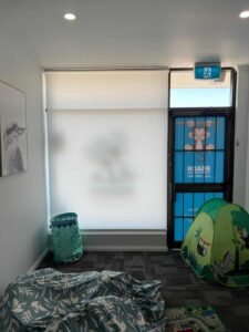 Light filtering roller blinds installed in a Central Coast daycare centre, providing glare reduction and safe privacy for children