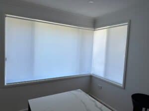 Light Filter Roller Blinds – Point Claire Install Light filter roller blinds installed in a Central Coast bedroom with corner windows – Point Claire project