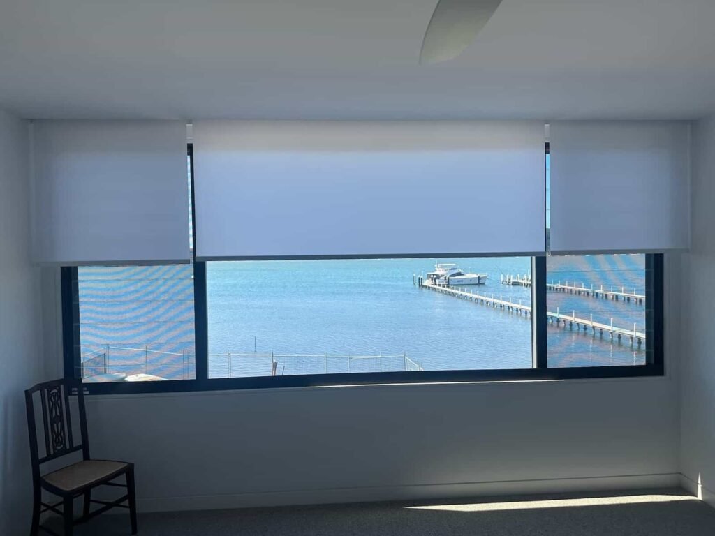 Light filtering roller blinds installed in a Central Coast home with water views, providing privacy and soft natural light