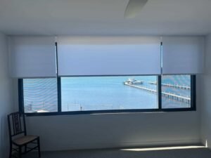 Light filtering roller blinds installed in a Central Coast home with water views, providing privacy and soft natural light