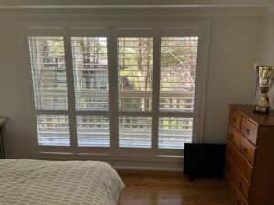 PVC plantation shutters in bedroom windows for privacy, airflow, and light control