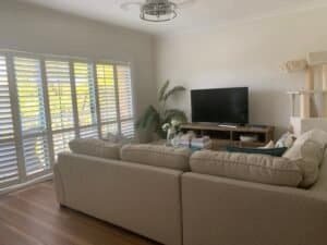 PVC plantation shutters in loungeroom windows providing privacy, airflow, and modern style