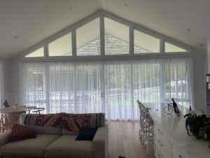 Sheer curtains in dining room creating soft light and elegant atmosphere