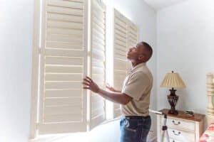 Professional Plantation Shutter Installation Installer fitting plantation shutters with precision