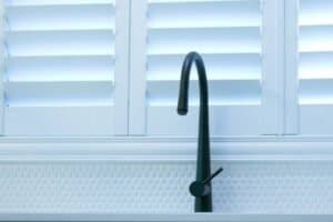Plantation Shutters Above Sink – Durable & Water-Resistant Moisture-resistant plantation shutters above a kitchen sink