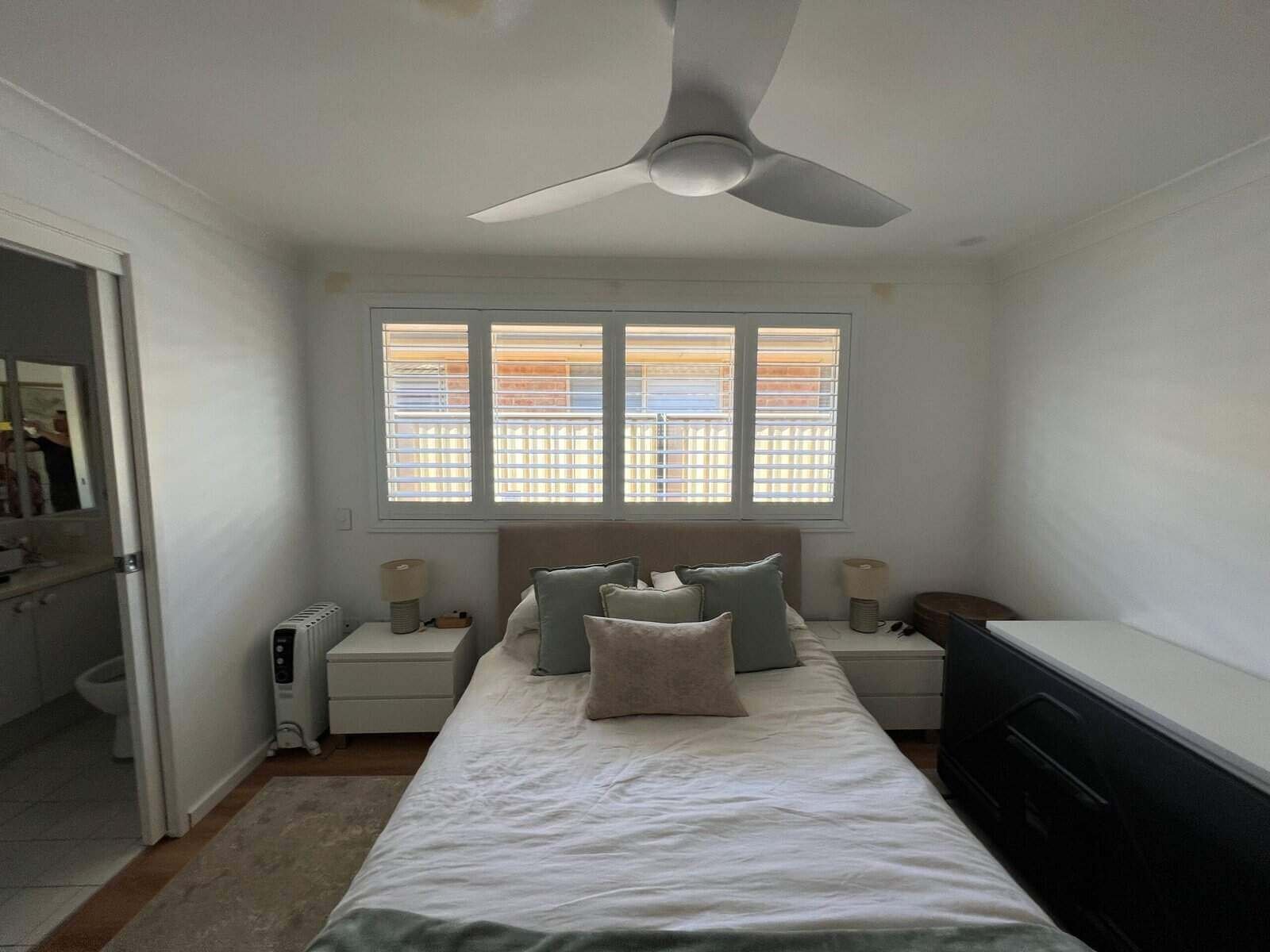 Do plantation shutters block out cold – bedroom example Bedroom with white plantation shutters helping to block out cold and improve insulation