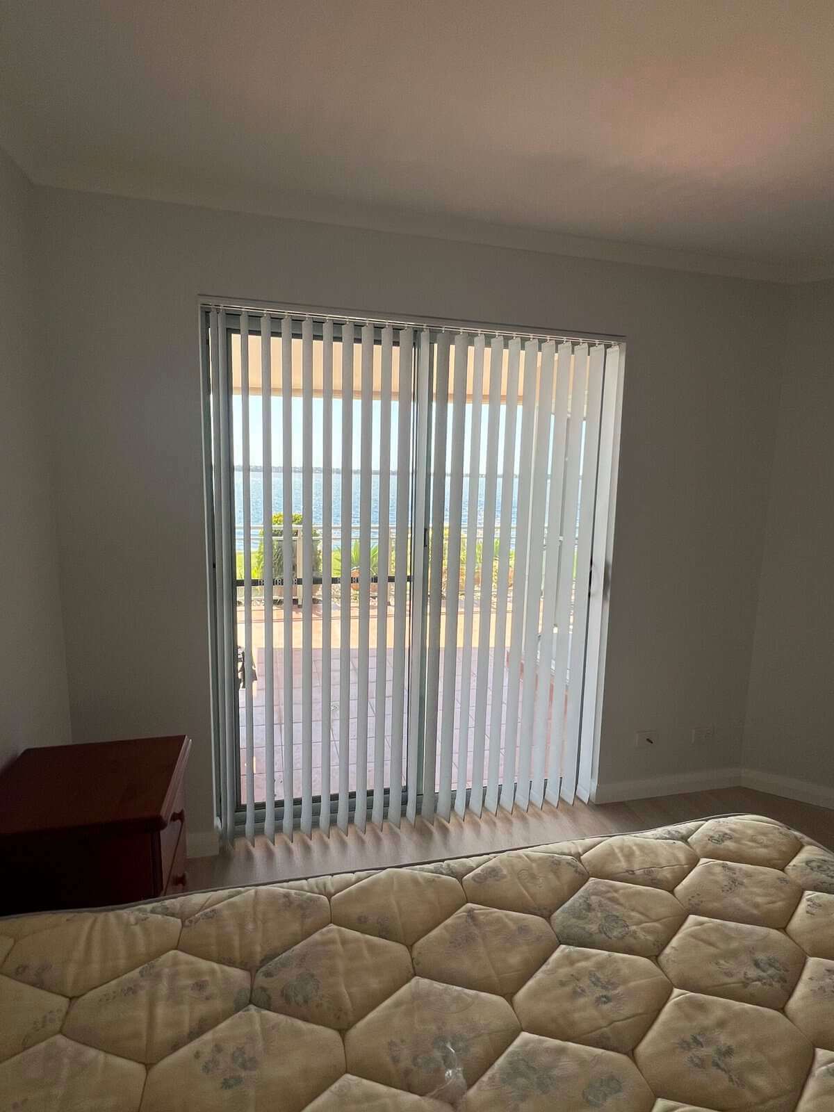 Vertical blinds for light control in a bright modern living room filtering sunlight