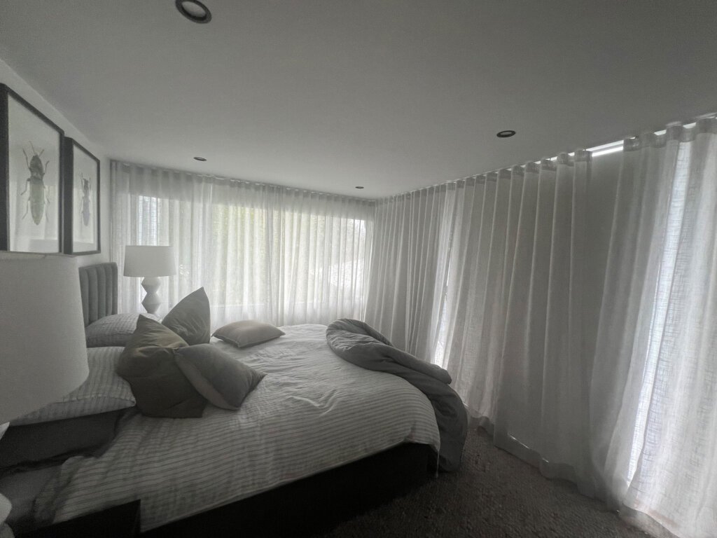 Sheer Bedroom Curtains Central Coast – Floor-to-Ceiling Elegance by The Blind Crew Floor-to-ceiling sheer curtains installed by The Blind Crew in a Central Coast bedroom, offering soft natural light and elegant privacy.