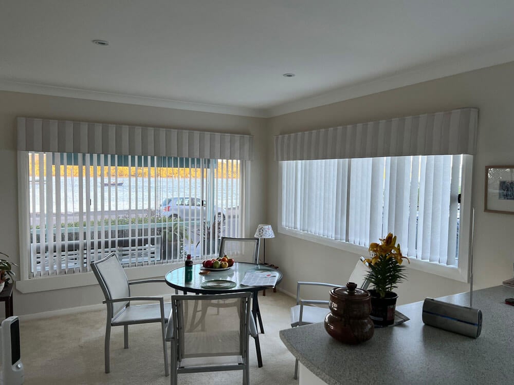 How long does installation take once I order vertical blinds showing a professional installer fitting vertical blinds in a modern home living room.