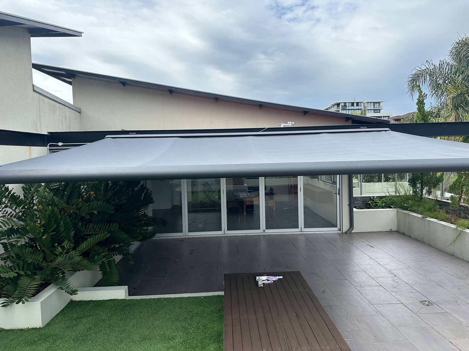 Outdoor Awning – Sun and Weather Protection for Central Coast Homes Modern outdoor awning providing shade over a patio area and reducing indoor heat