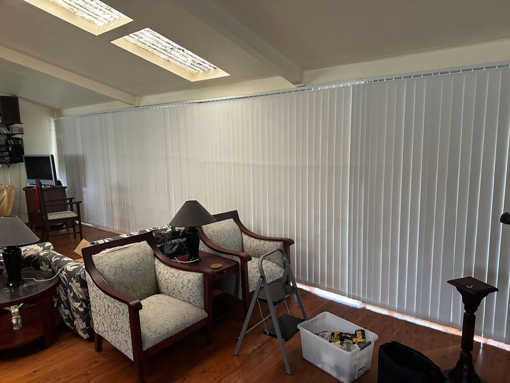 Vertical blind extra-wide track capability covering large sliding glass doors with seamless movement.