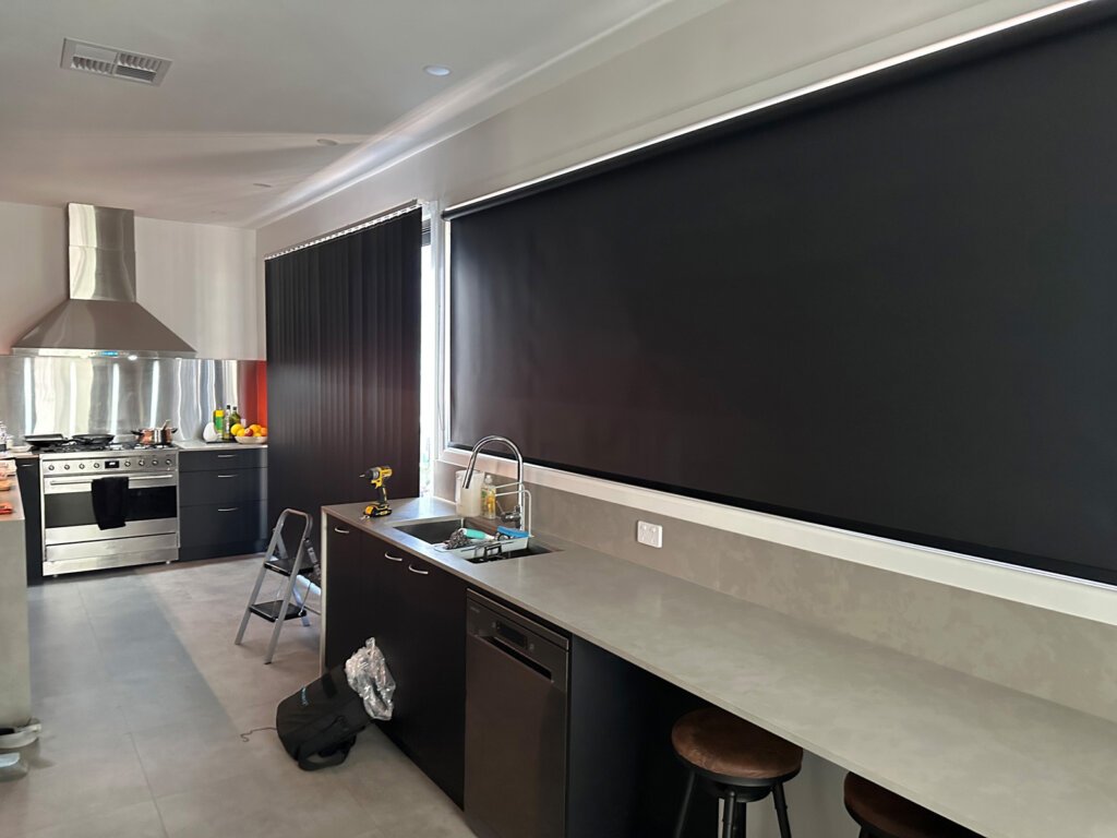 Close-up of window showing slight moisture behind roller blinds, illustrating the question do roller blinds cause condensation.