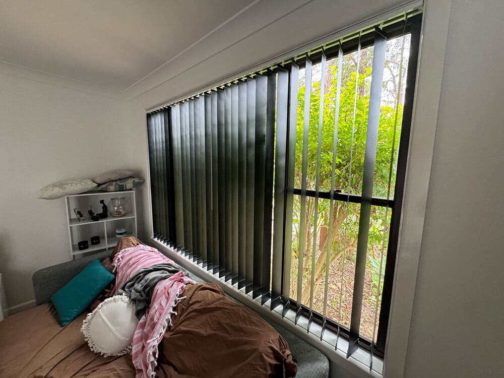 Are vertical blinds good for sunrooms showing bright indoor space with soft filtered light through tall vertical blinds.