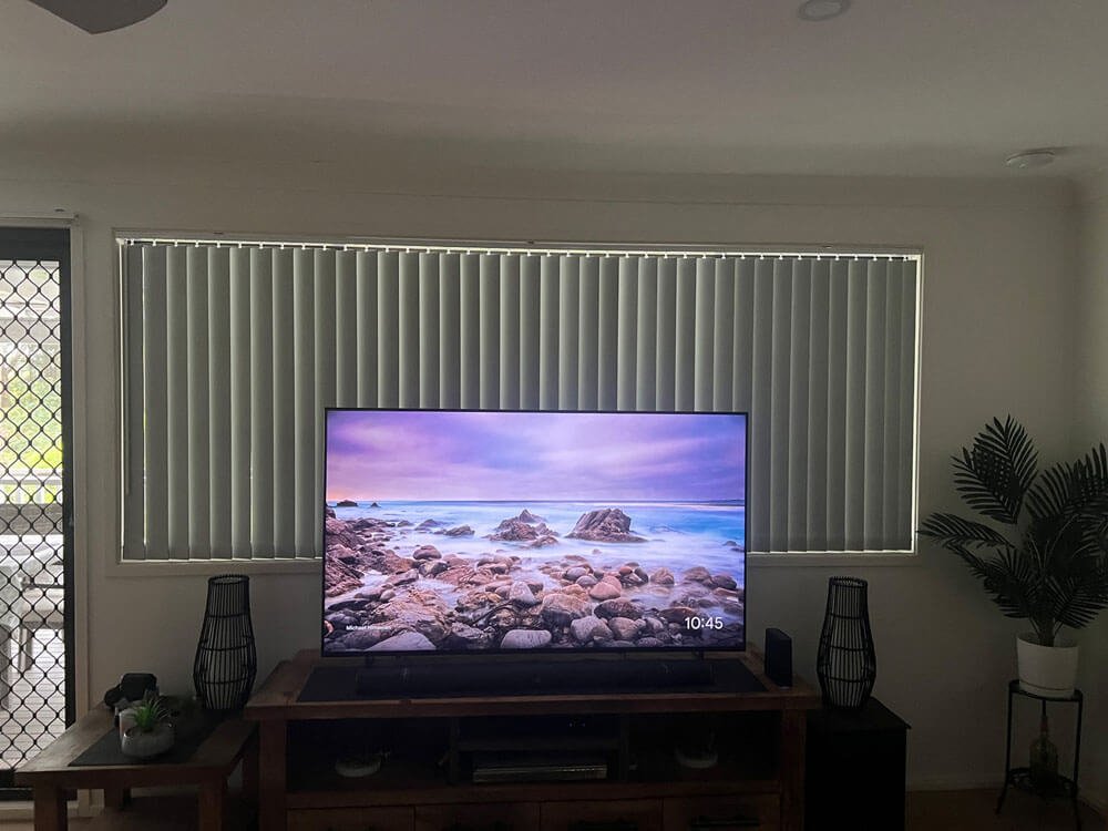 Vertical blinds stacking options showing left, right, and centre split configurations in a bright living room.