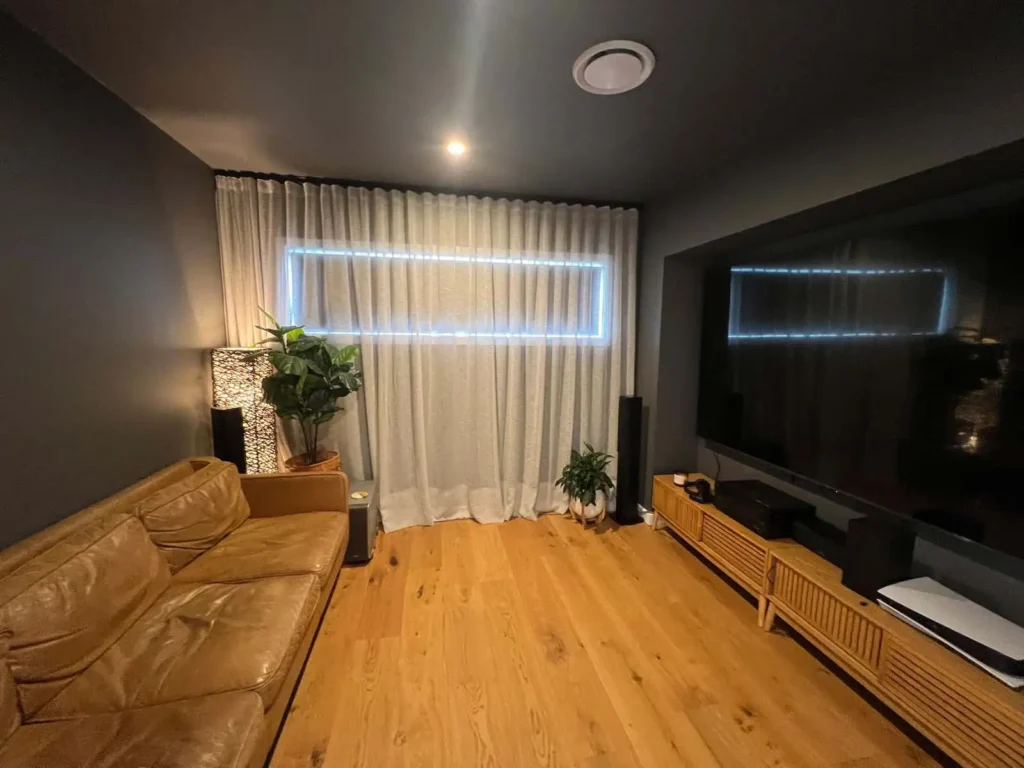 Curtains add acoustic comfort in a modern living room by absorbing noise and softening echo.