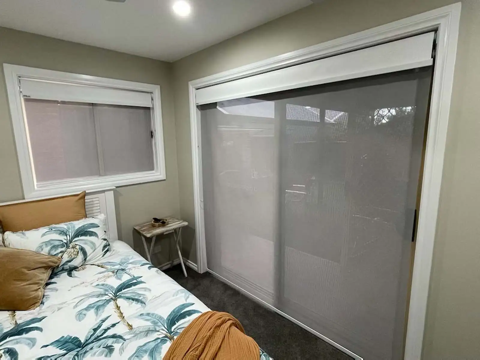 Day and night roller blinds installed in a Central Coast bedroom, offering full privacy and light control.