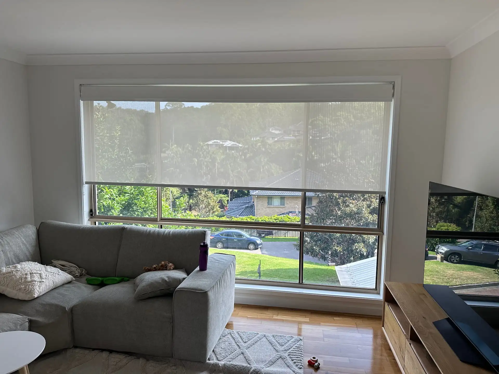 Double roller blinds filtering light while maintaining outdoor views in a Central Coast living room.