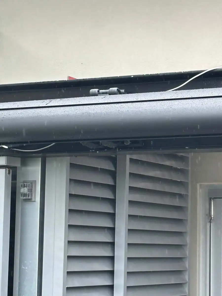 Outdoor aluminium plantation shutters Central Coast — weather-resistant, coastal-grade installation in rain conditions.