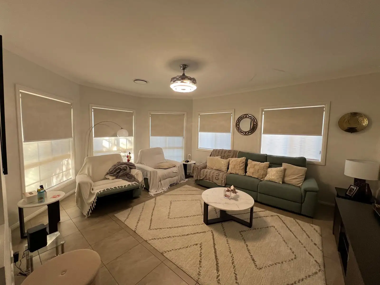 Custom roller blinds in a Central Coast living room providing privacy and soft natural light