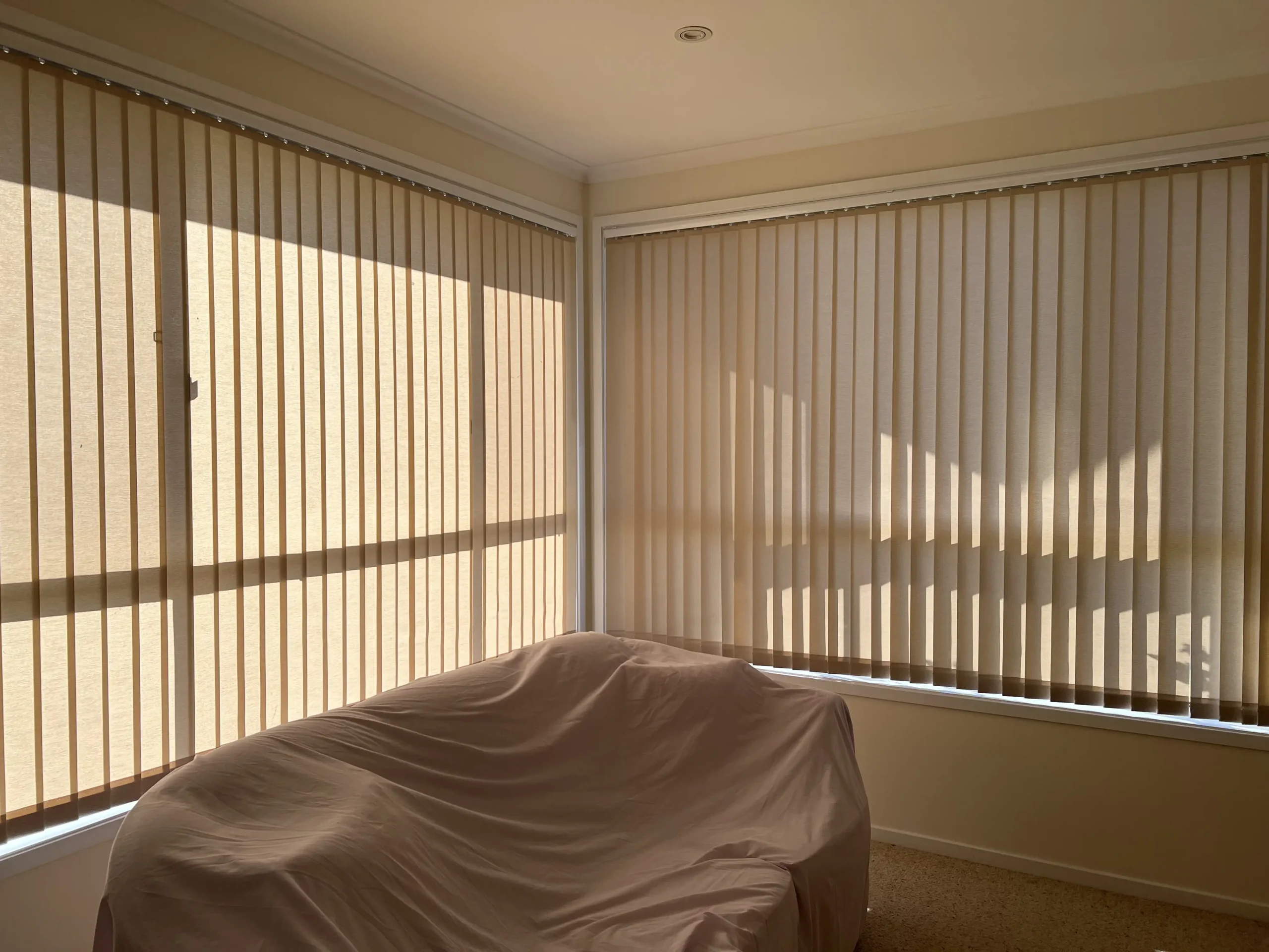 Light Filtering Vertical Blinds – The Blind Crew ight filtering vertical blinds allowing soft daylight into a Central Coast living space – installed by The Blind Crew.