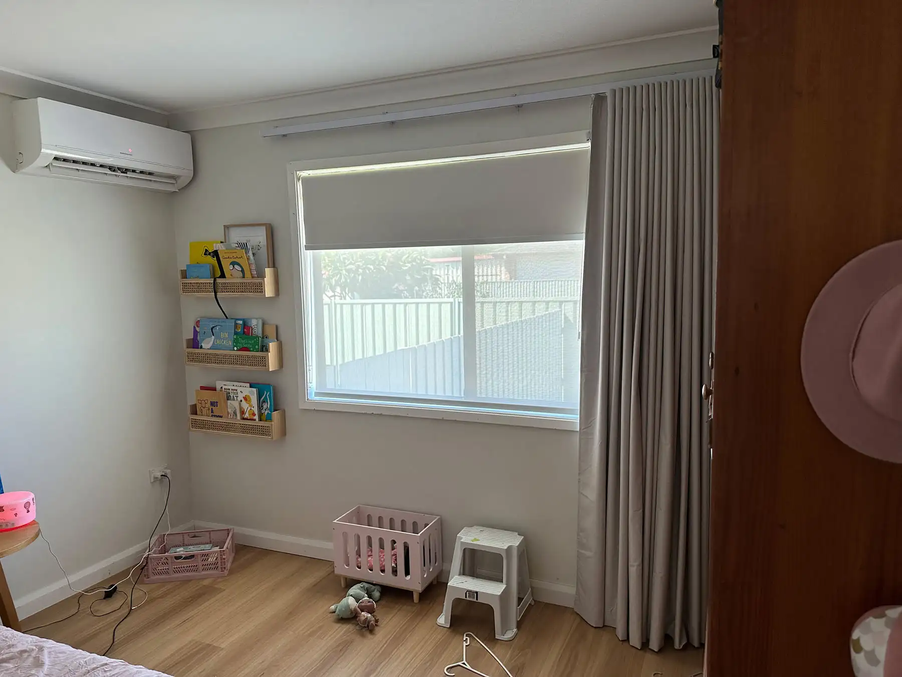 Roller blinds for nursery rooms installed in a wide nursery interior to reduce light