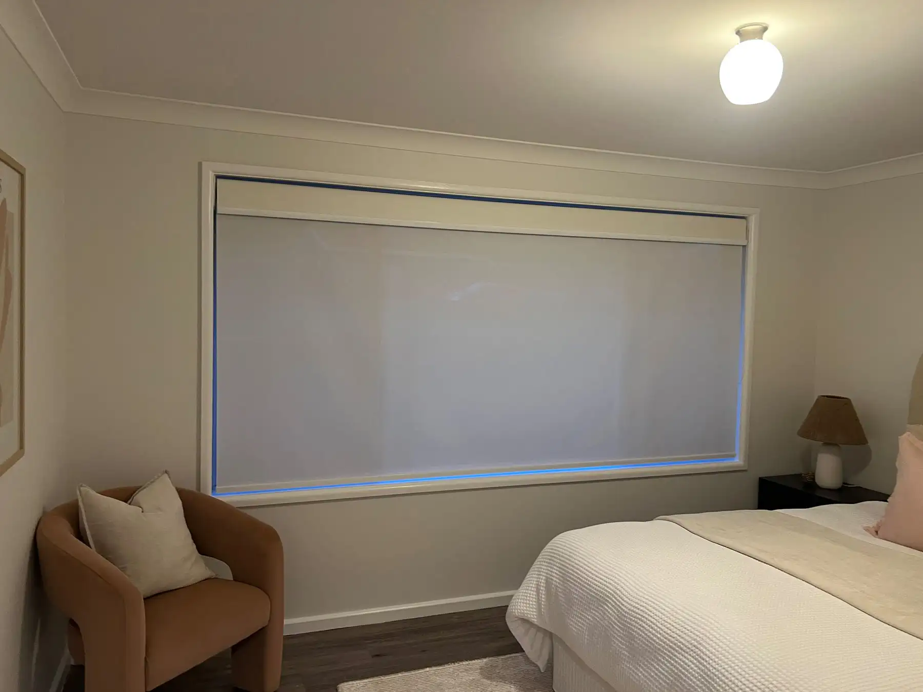 Roller Blinds for Bedroom Windows Roller blinds installed as bedroom blinds in a wide bedroom view, providing privacy and light control