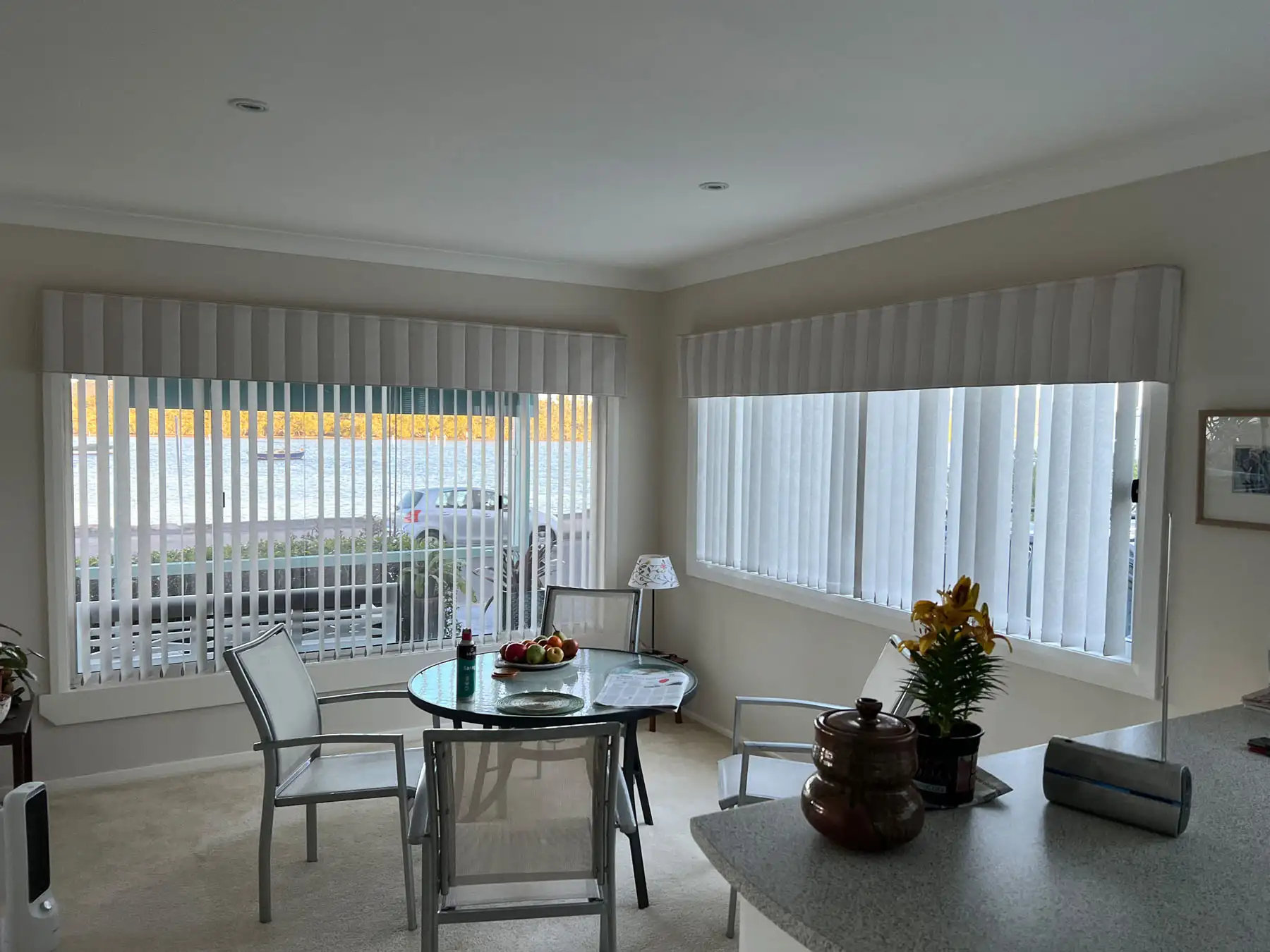 Vertical Blinds as Dining Room Blinds Vertical blinds used as Dining Room Blinds in a wide dining room view, providing light control and privacy