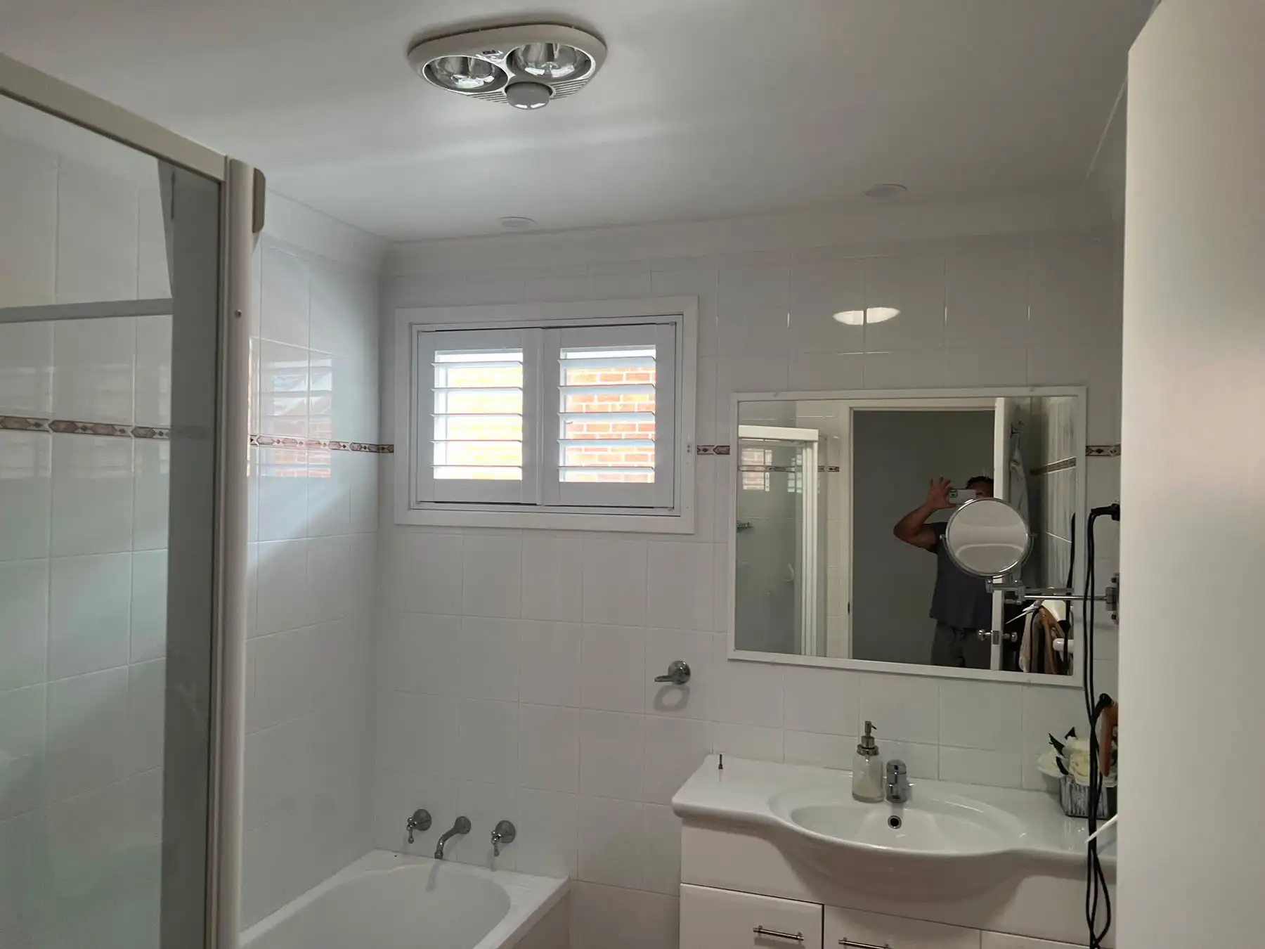 Plantation shutters installed in a bathroom, providing privacy and adjustable light control