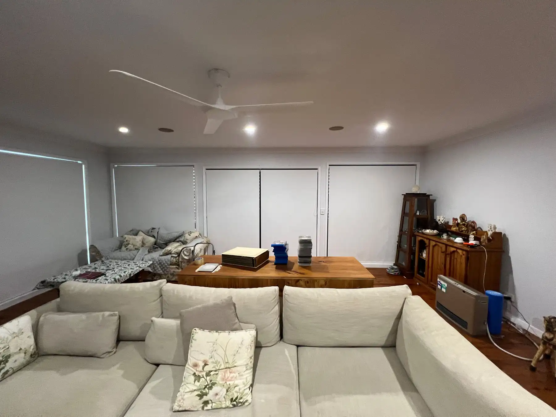 Roller blinds used as living room blinds in a wide living room view, providing light control and privacy
