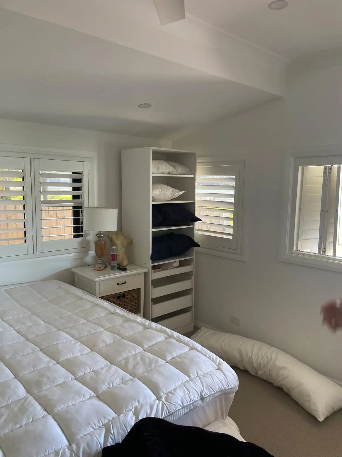 Plantation Shutters as Bedroom Blinds Plantation shutters used as bedroom blinds in a wide bedroom view, providing privacy and light control