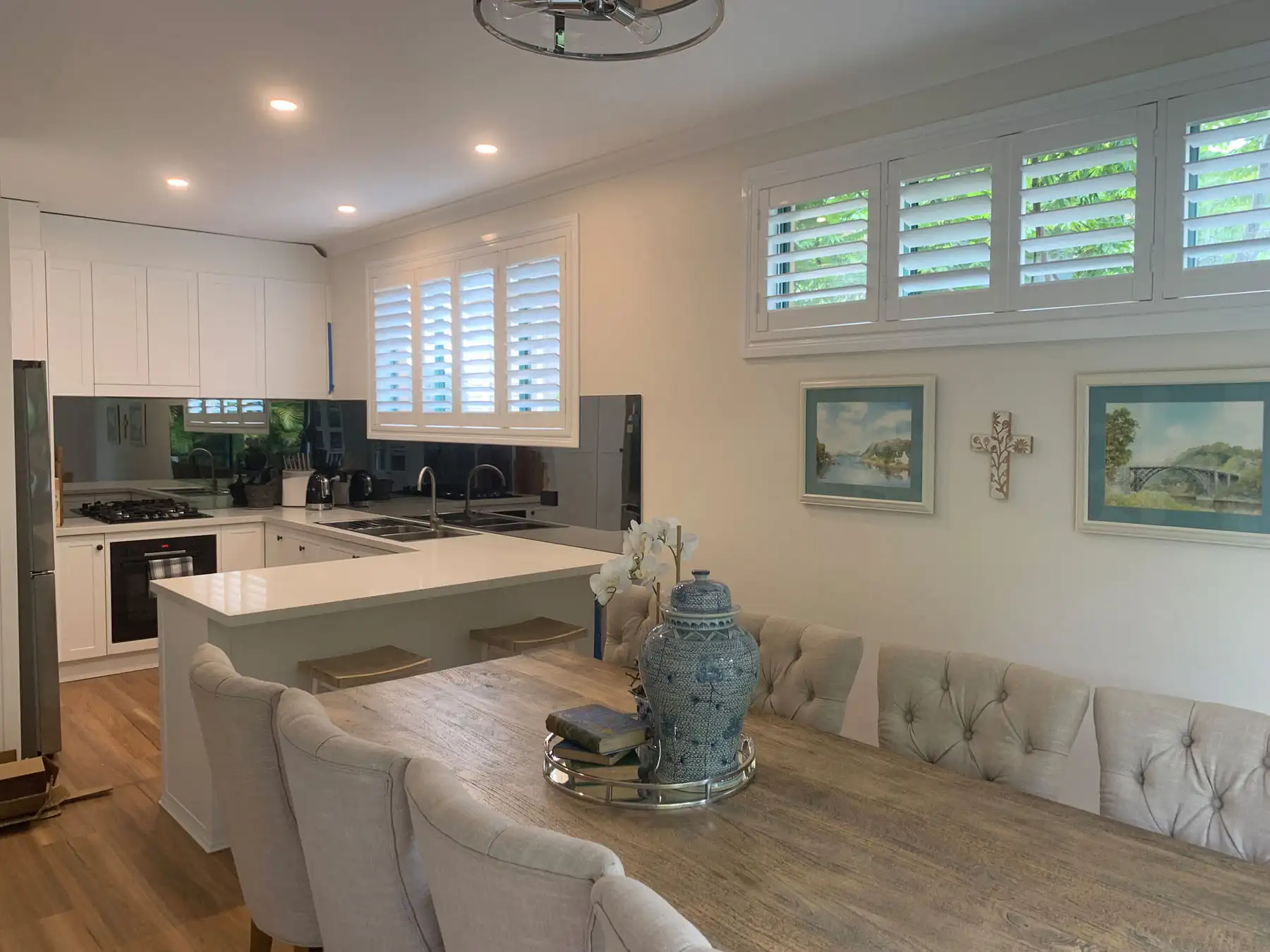 Plantation Shutters as Dining Room Blinds Plantation shutters used as dining room blinds in a wide dining room view, providing light control and privacy