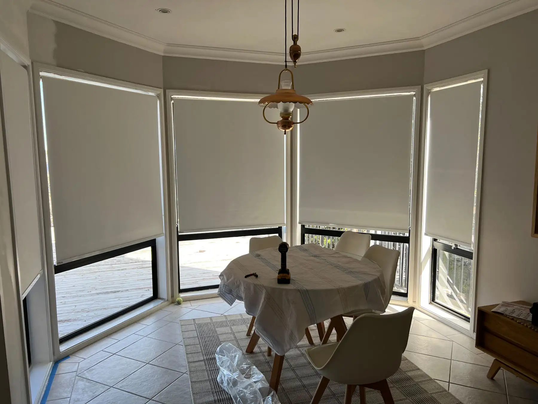 Roller blinds installed as blinds for bay windows in a wide bay window view, providing clean light control